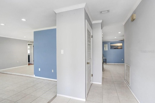 corridor featuring ornamental molding and light tile patterned flooring