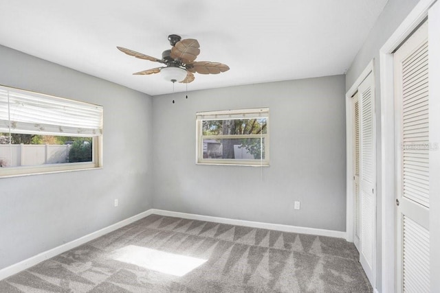 unfurnished bedroom with multiple windows, ceiling fan, and carpet floors