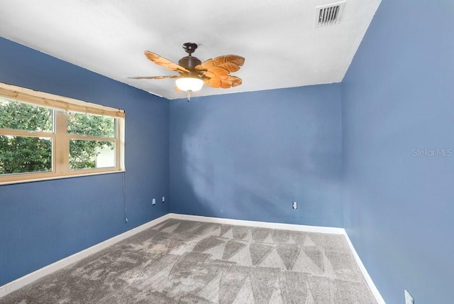 spare room featuring carpet flooring, ceiling fan, and lofted ceiling