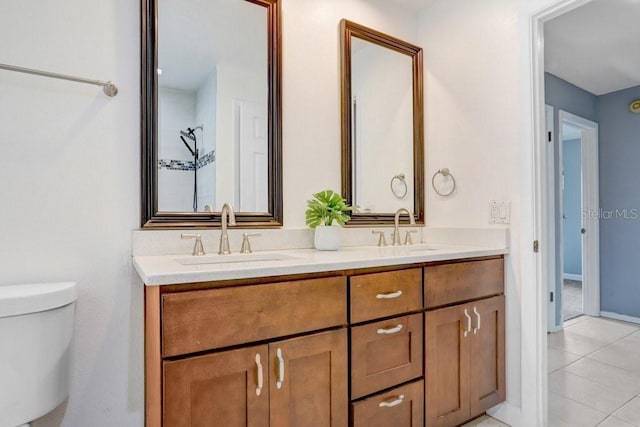 bathroom with tile patterned floors, vanity, and toilet