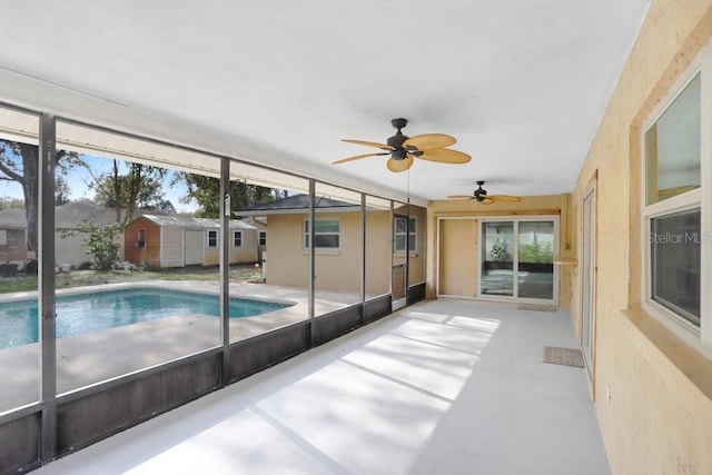 view of swimming pool featuring ceiling fan and a patio