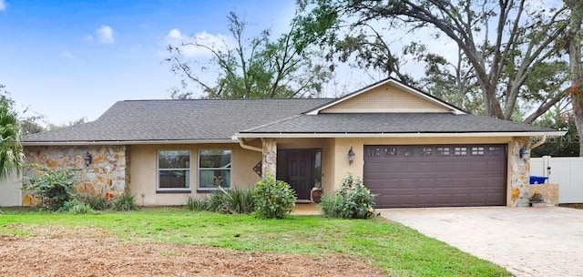 single story home featuring a garage and a front yard