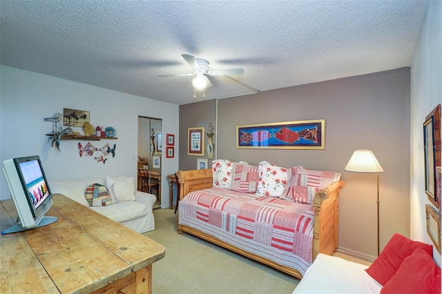 bedroom with ceiling fan, a closet, carpet, and a textured ceiling