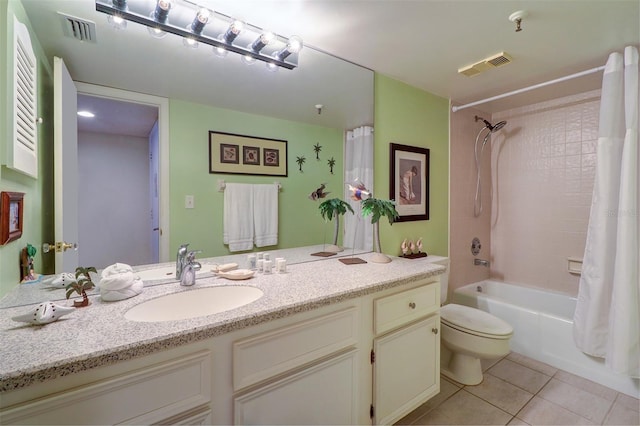 full bathroom featuring toilet, vanity, tile patterned floors, and shower / bath combo with shower curtain