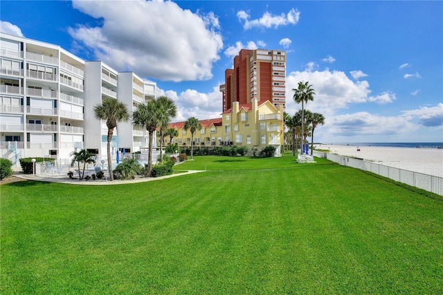 view of property's community featuring a lawn and a water view