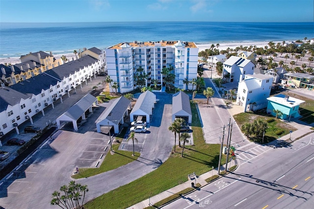 drone / aerial view featuring a water view and a view of the beach