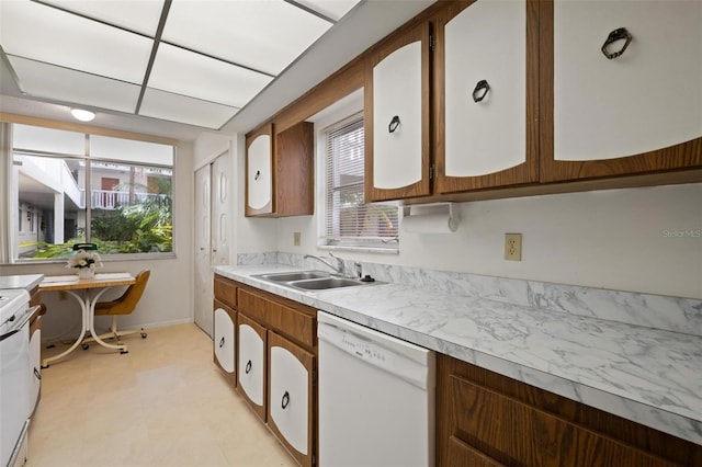 kitchen with range, a wealth of natural light, dishwasher, and sink