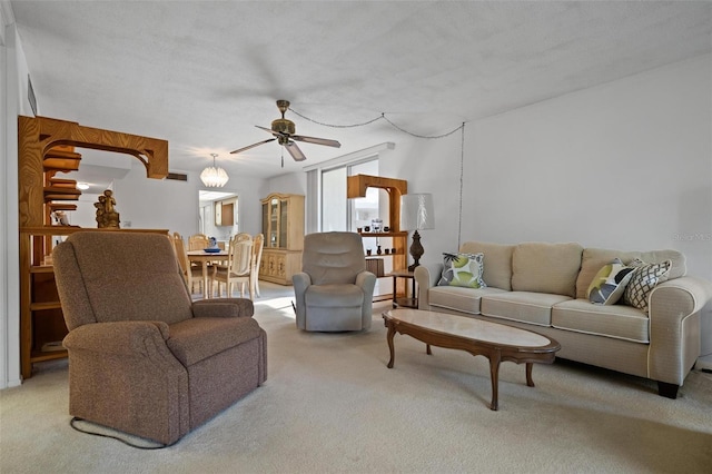 living room with light colored carpet and ceiling fan