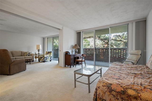 bedroom with floor to ceiling windows, carpet floors, and access to outside