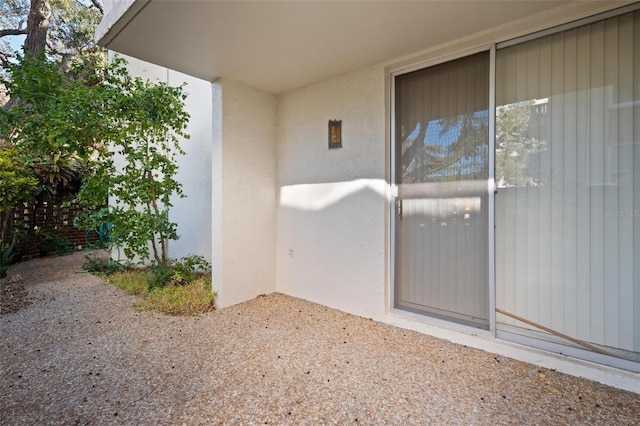 property entrance with stucco siding