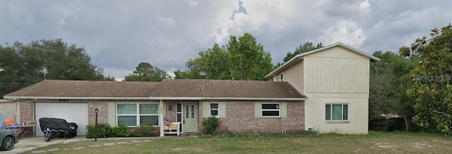 view of front property featuring a front yard and a garage