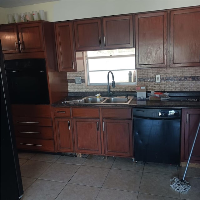 kitchen featuring black appliances, backsplash, light tile patterned floors, and sink