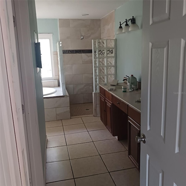 bathroom with tile patterned flooring, vanity, and independent shower and bath