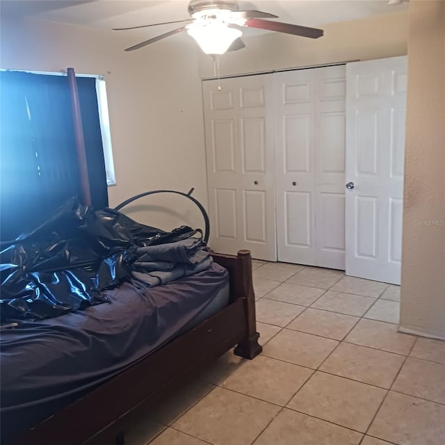 tiled bedroom with a closet and ceiling fan