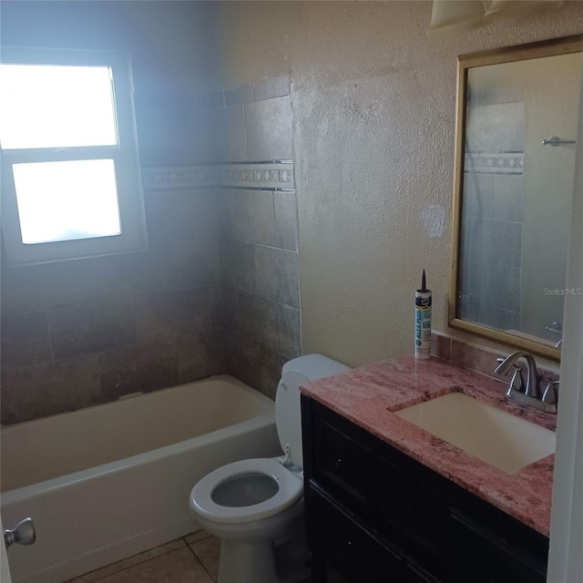 full bathroom with tile patterned floors, vanity, toilet, and tiled shower / bath