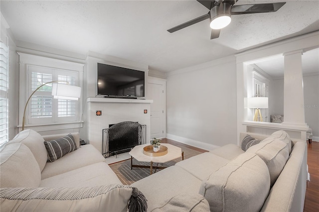 living room with ornamental molding, ceiling fan, and hardwood / wood-style flooring