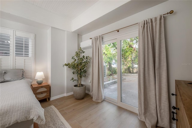 bedroom featuring access to exterior and light wood-type flooring