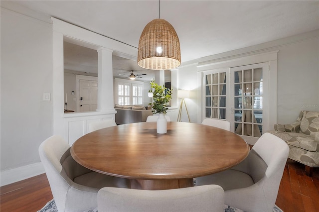 dining room featuring decorative columns, ceiling fan, crown molding, and dark hardwood / wood-style floors