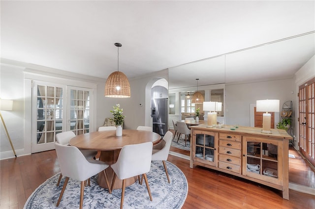 dining space with french doors and hardwood / wood-style floors