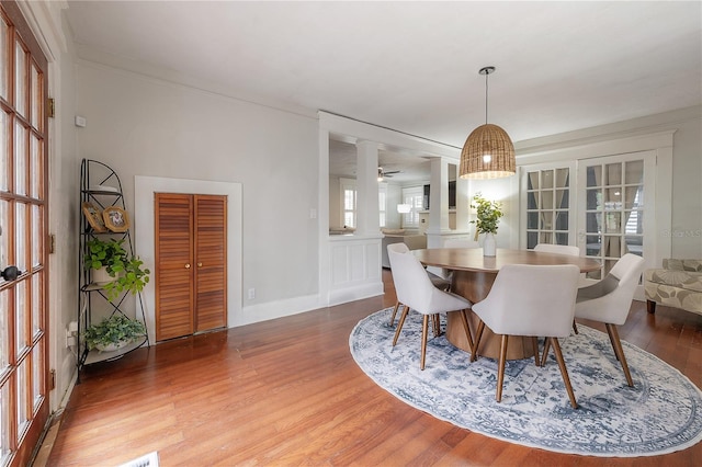 dining room featuring hardwood / wood-style floors, ceiling fan, and ornamental molding