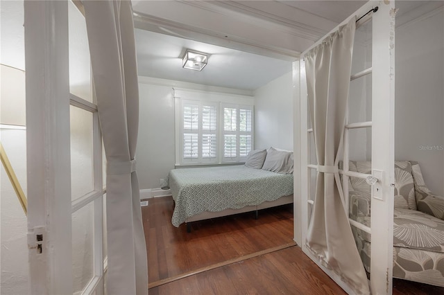 bedroom featuring hardwood / wood-style floors and crown molding