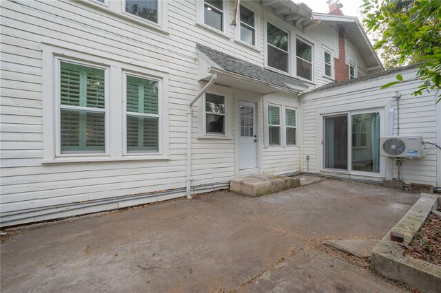 doorway to property featuring ac unit and a patio area