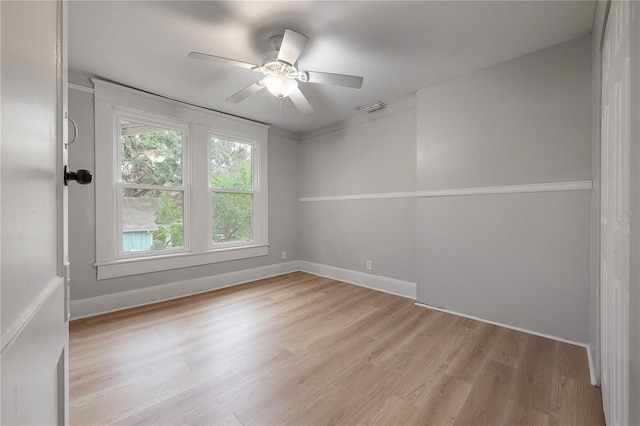 unfurnished room with ceiling fan and light wood-type flooring