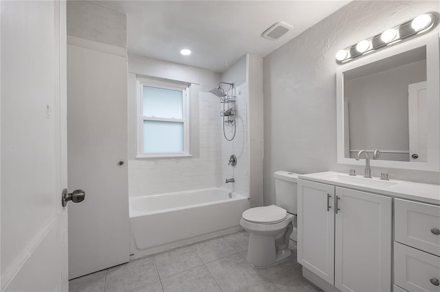 full bathroom featuring vanity, tiled shower / bath combo, tile patterned floors, and toilet