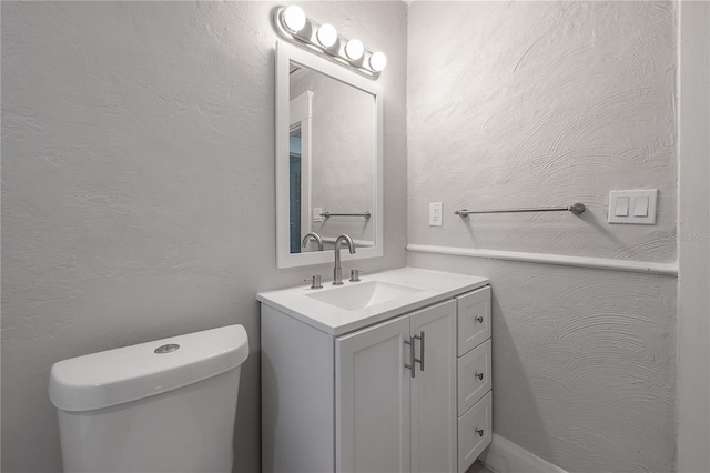 bathroom featuring toilet and vanity