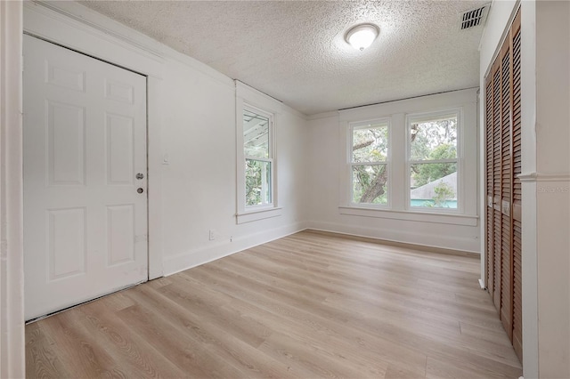 entryway featuring a textured ceiling and light wood-type flooring