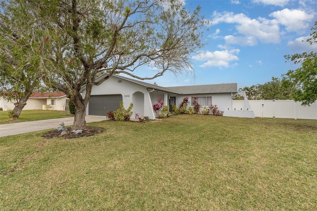 ranch-style house featuring a front yard and a garage