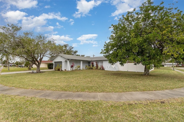 view of front facade with a front yard and a garage