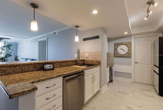 kitchen featuring sink, stainless steel dishwasher, dark stone countertops, pendant lighting, and white cabinets