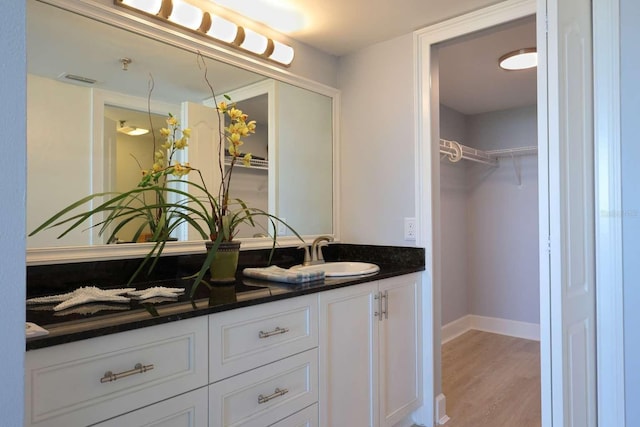 bathroom featuring vanity and wood-type flooring