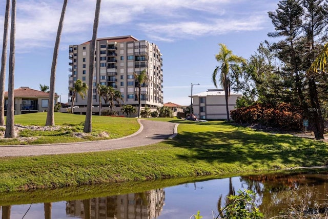 surrounding community featuring a yard and a water view