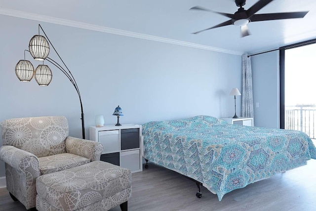 bedroom featuring hardwood / wood-style floors, ceiling fan, and ornamental molding