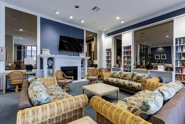 carpeted living room with built in shelves