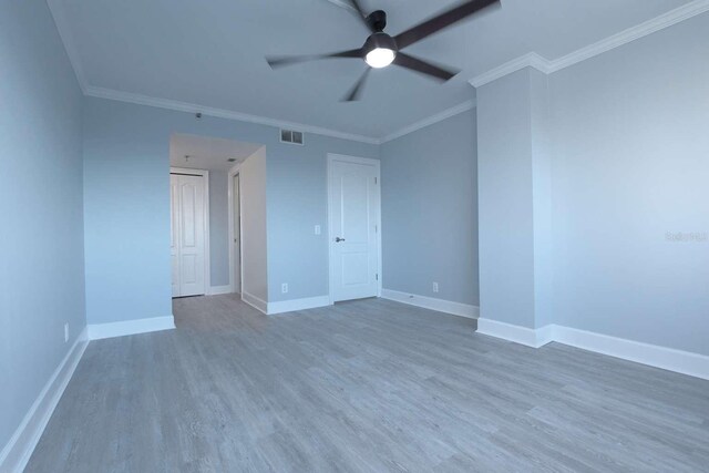 empty room with hardwood / wood-style flooring, ceiling fan, and ornamental molding