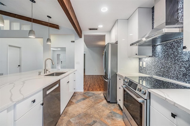 kitchen featuring sink, white cabinets, hanging light fixtures, stainless steel appliances, and wall chimney range hood