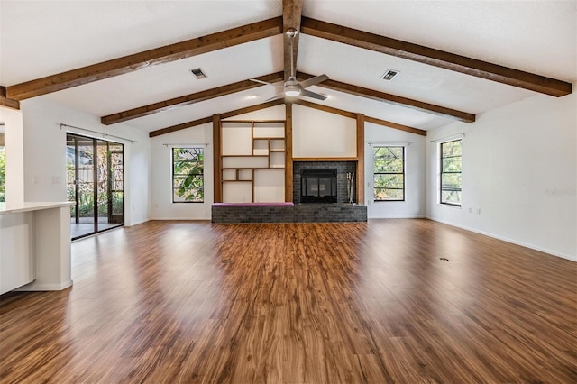 unfurnished living room with hardwood / wood-style flooring, a healthy amount of sunlight, a fireplace, and lofted ceiling with beams