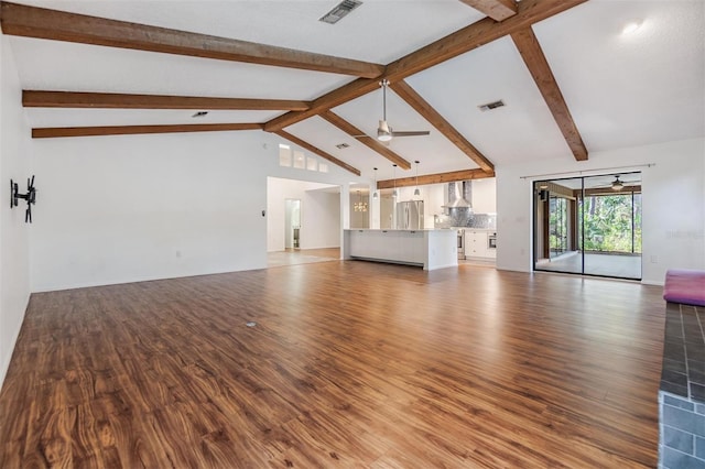 unfurnished living room featuring lofted ceiling with beams, ceiling fan, and hardwood / wood-style floors