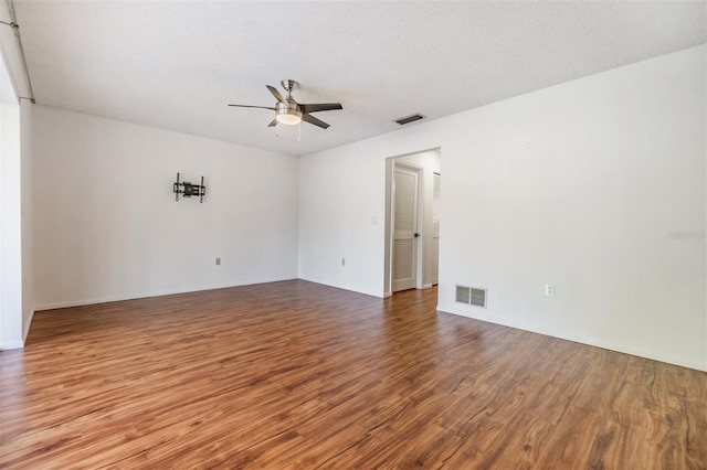 empty room featuring hardwood / wood-style floors, a textured ceiling, and ceiling fan