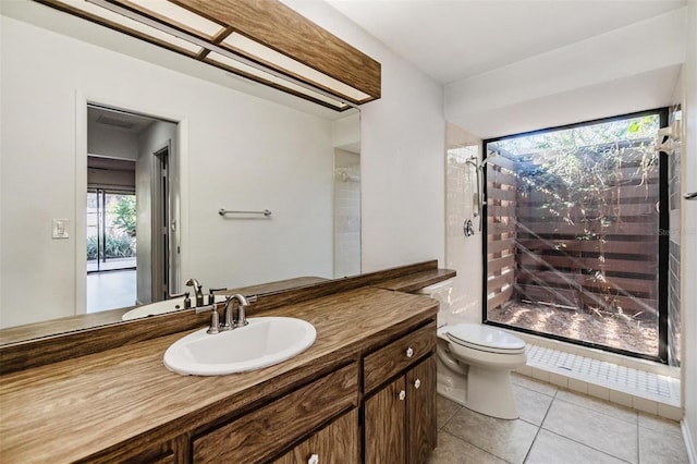 bathroom featuring tile patterned flooring, vanity, and toilet