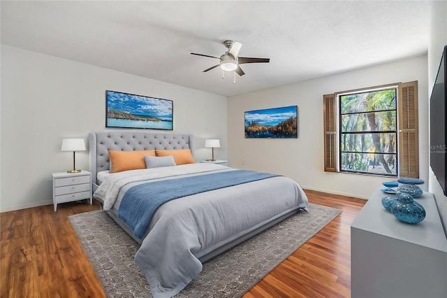 bedroom with dark hardwood / wood-style floors and ceiling fan