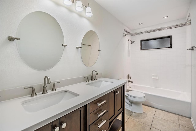 full bathroom featuring tile patterned floors, toilet, tiled shower / bath combo, and vanity