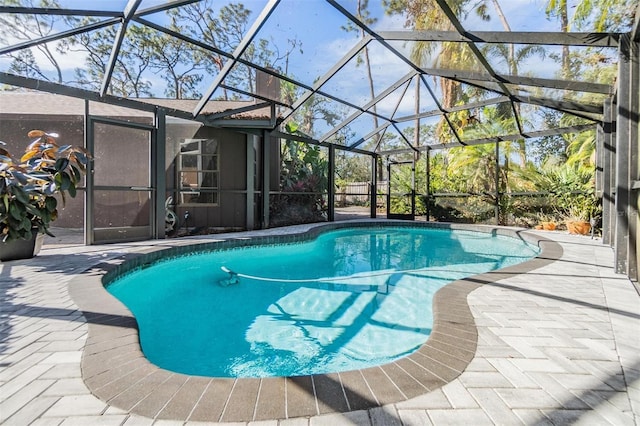 view of swimming pool with a patio and glass enclosure