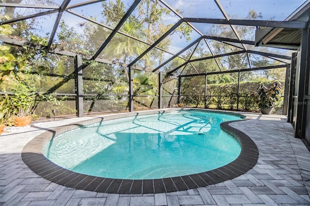 view of swimming pool featuring a lanai and a patio