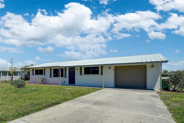 ranch-style home with a garage and a front lawn