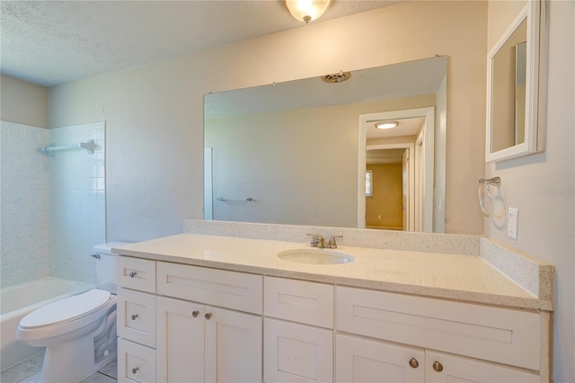 full bathroom with a textured ceiling, vanity, toilet, and tiled shower / bath combo