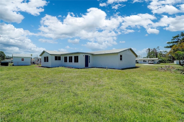 rear view of house with a yard